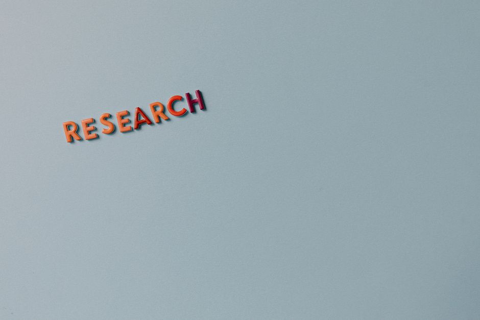 Minimalist image with the word 'RESEARCH' in colorful letters on a plain background.